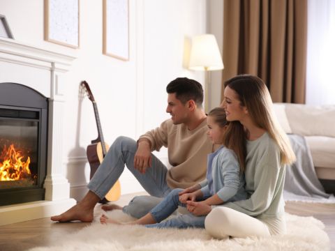 parents with daughter in front of fire - Propane & Heating Oil Products page image