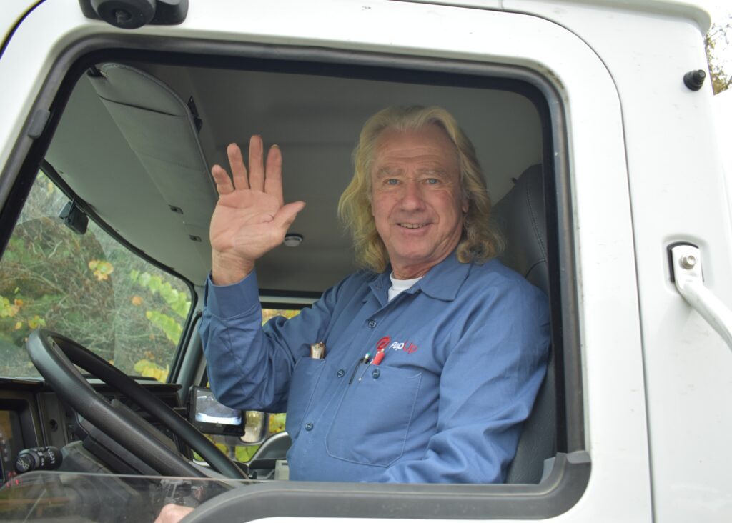 PepUp propane delivery driver John McGinnis, contributor to the PepUp blog, waves from the cab of his delivery truck.