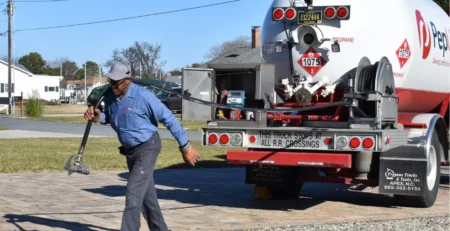 How to order emergency propane delivery in winter and stay warm and safe, blog post image of driver delivering home propane.