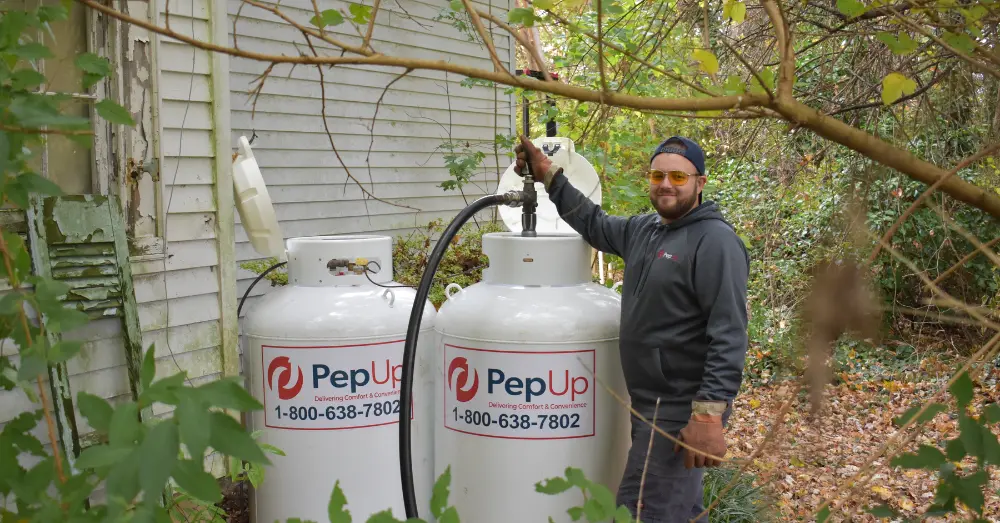 A PepUp home propane delivery driver fills a residential propane tank in Delaware.