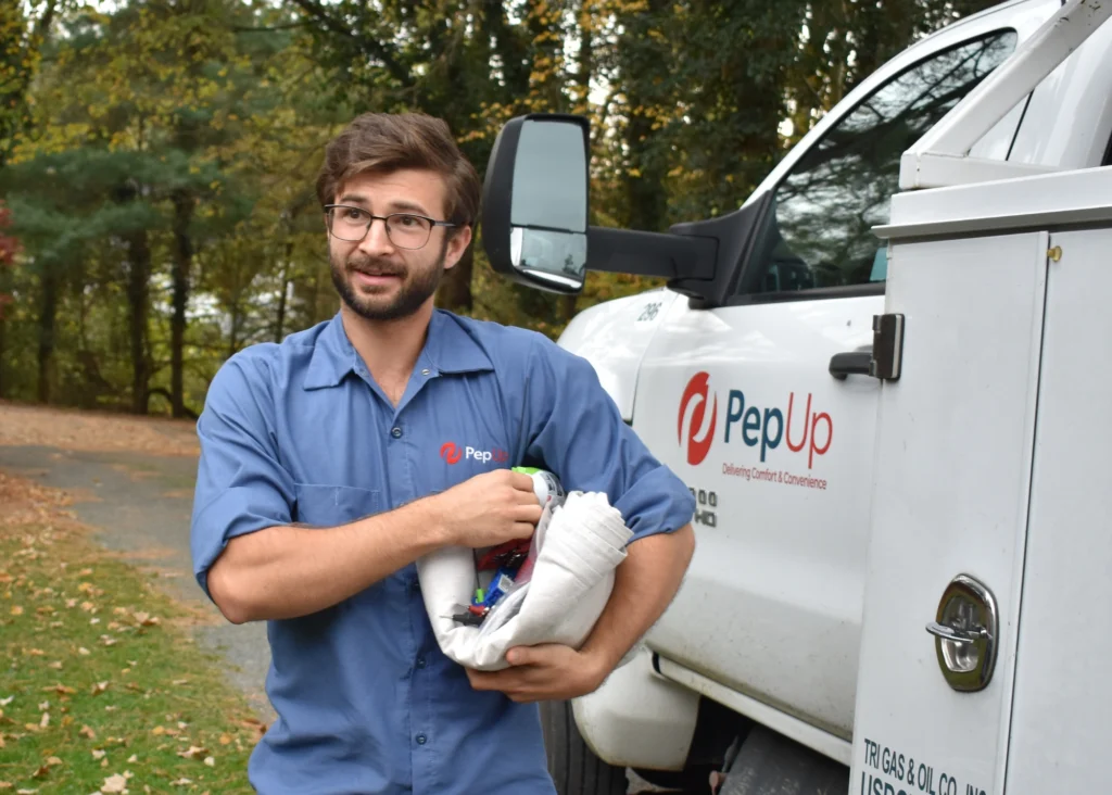 PepUp Service Technician Joey Weddell helps with LPG tank delivery in Galena.
