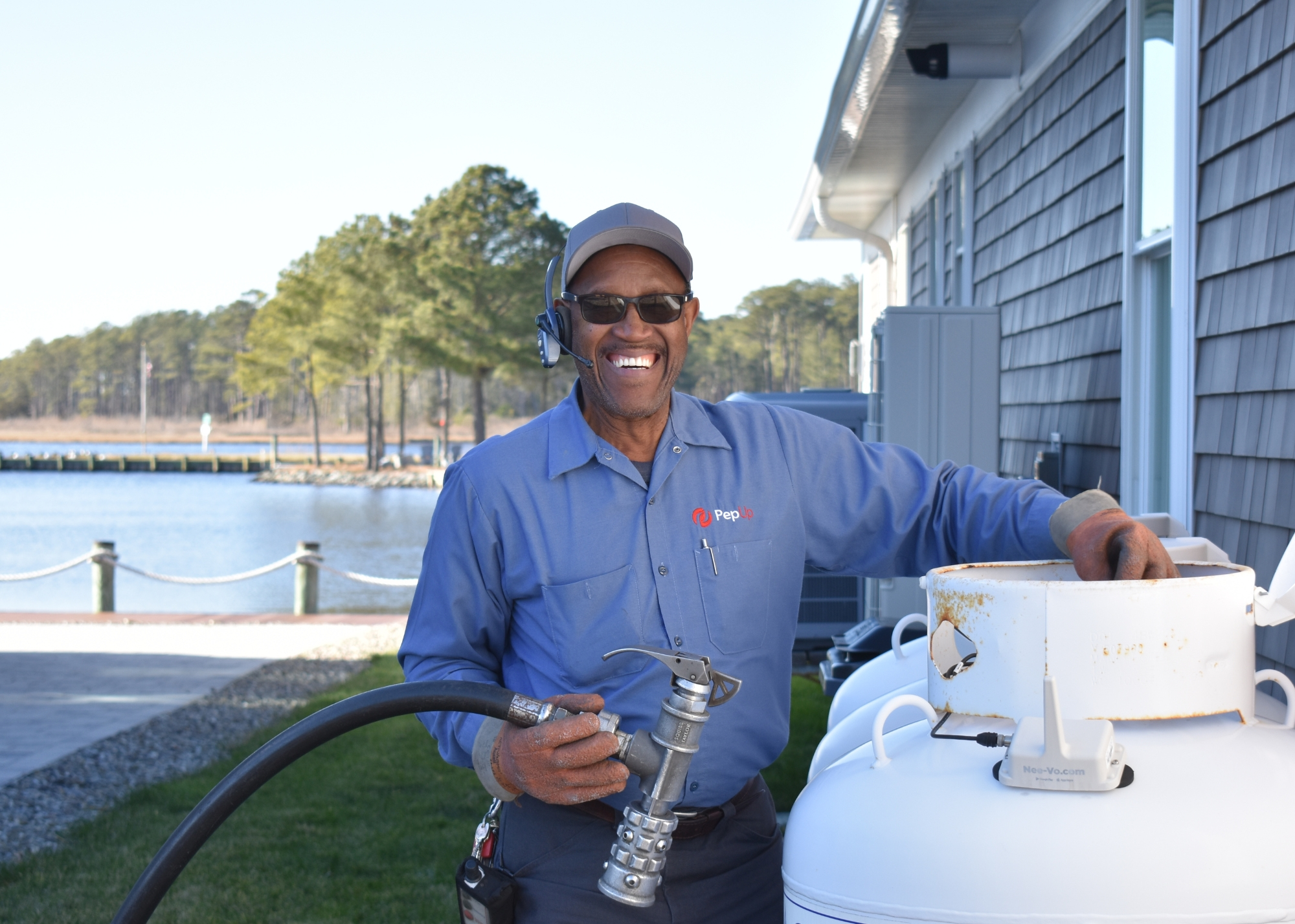 An image of PepUp Delivery Driver Ben Fulton preparing to fill a customer's propane tank.