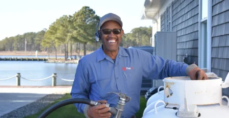 An image of PepUp Delivery Driver Ben Fulton preparing to fill a customer's propane tank.