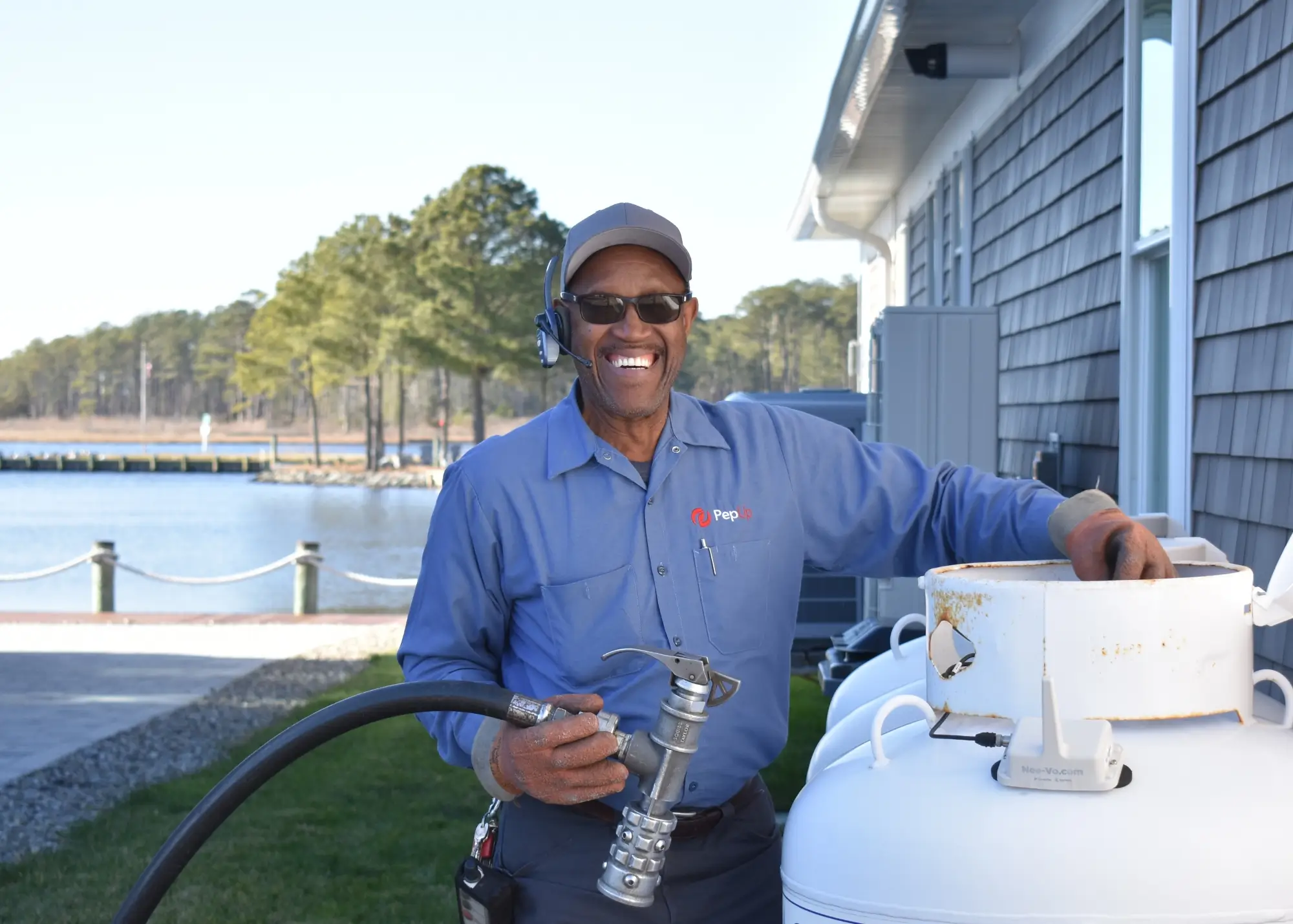 An image of PepUp Delivery Driver Ben Fulton preparing to fill a customer's propane tank.