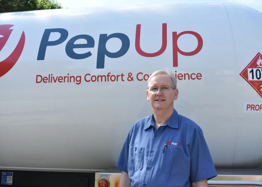 Photo of Bobby Callahan in front of a PepUp propane delivery truck, in the fleet fueling stations blog.