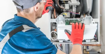 Image of a technician performing propane home furnaces inspection.