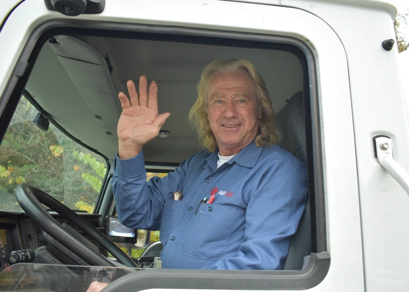 John McGinnis, PepUp delivery driver in Galena, waves from the cab of his propane delivery truck.