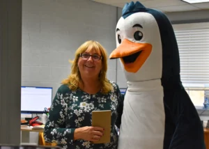 PepUp Energy Specialist Kathy Carst takes a break from providing propane customer support to take a quick picture with Trip the Penguin, PepUp's mascot.