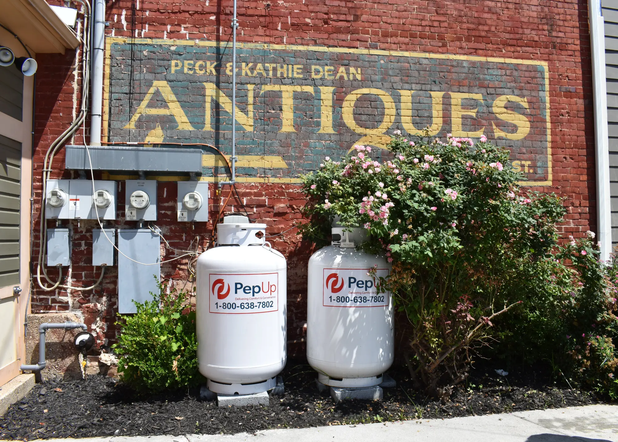 An image of new PepUp propane tanks beside a local antiques store in Federalsburg, in the blog about old propane tanks.