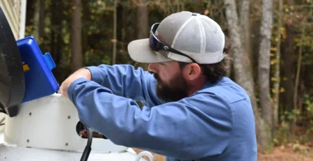 A PepUp service technician performs safety checks on a propane tank before a freeze.