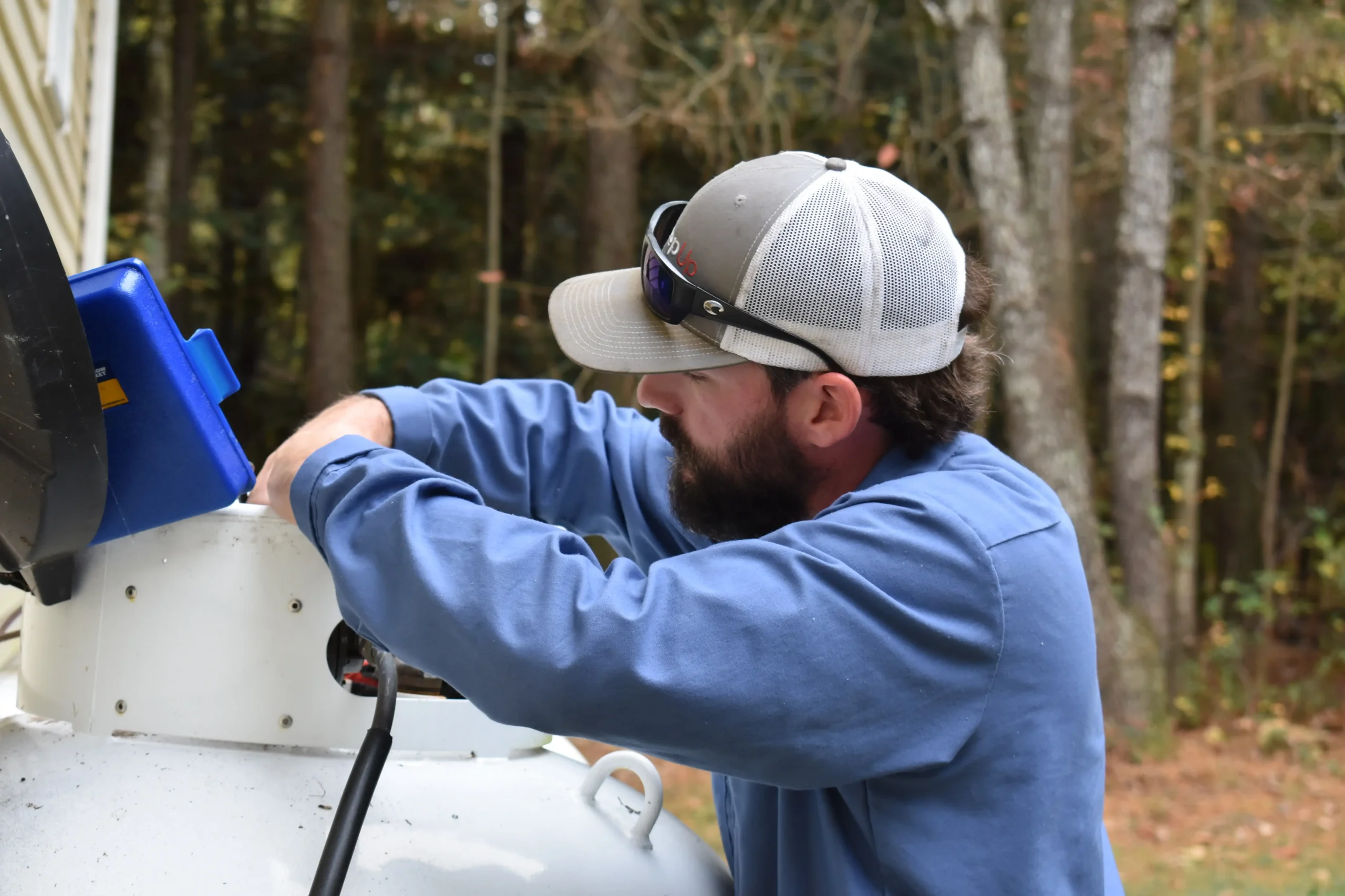 A PepUp service technician performs safety checks on a propane tank before a freeze.