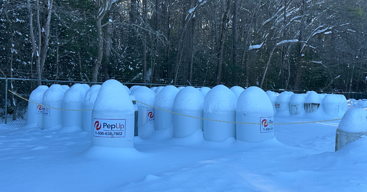 Image of snow-covered PepUp propane tanks.