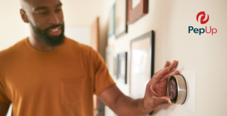 A customer adjusts a propane heat pump system using a smart thermostat.