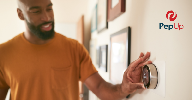 A customer adjusts a propane heat pump system using a smart thermostat.