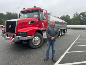 PepUp's 2025 Top 5 Safe Driver Eric Reifsnyder poses with a smile in front of his diesel fuel delivery truck.