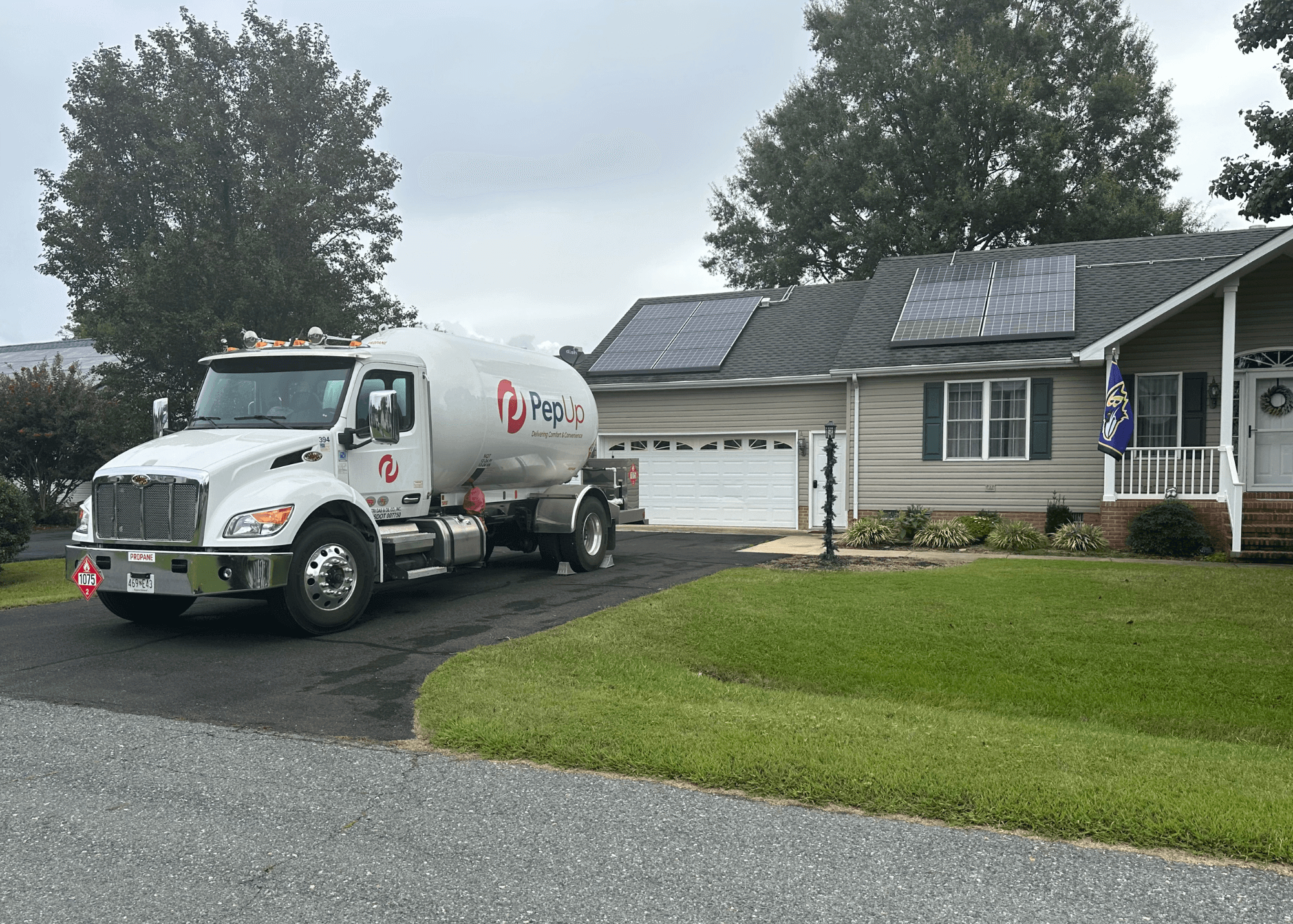 PepUp propane delivery truck at an environmentally friendly Delmarva home with solar panels.