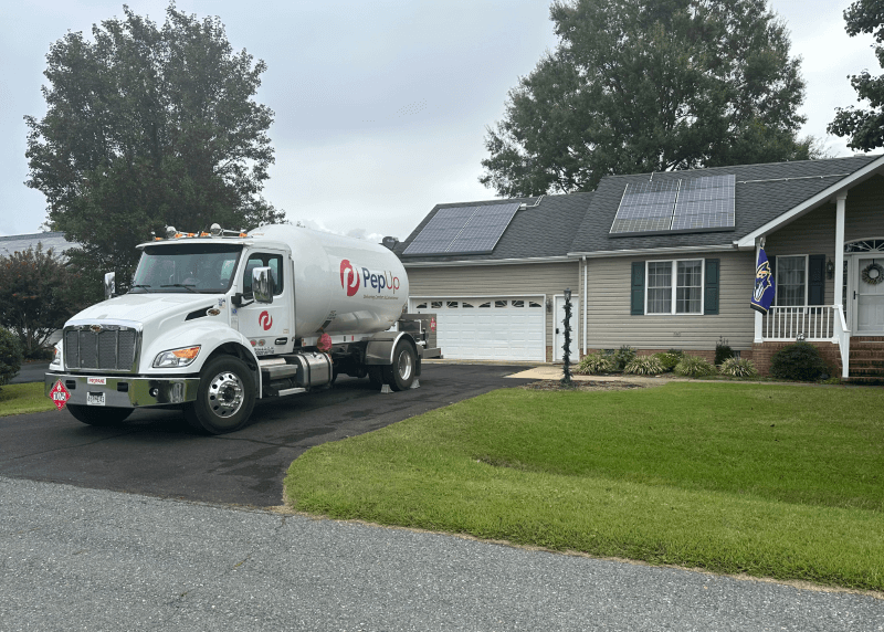 PepUp propane delivery truck at an environmentally friendly Delmarva home with solar panels.