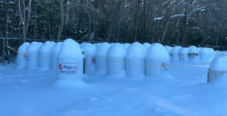 Image of snow-covered PepUp propane tanks.