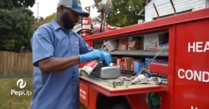 A PepUp technician cleans a heating system component while providing service at a Sussex County residence.