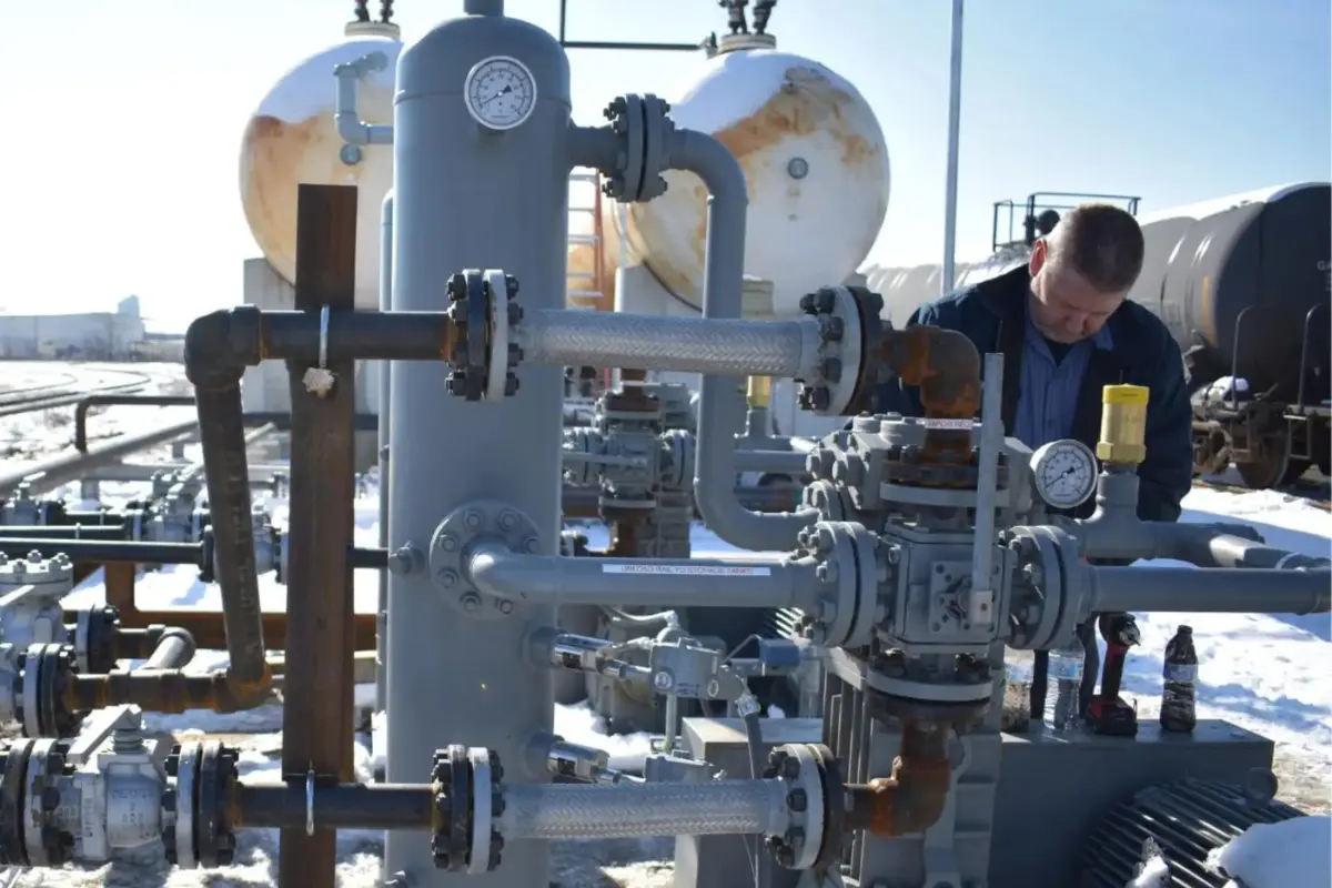 A PepUp delivery driver checks safety valves after a delivery to a local logistics bulk fuel storage tank.
