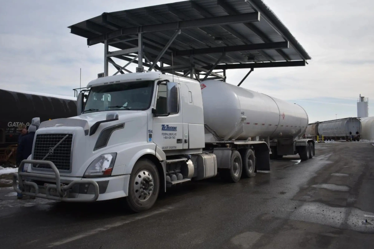 PepUp regional trucking carrier, customer truck refueling at large fuel storage tanks.