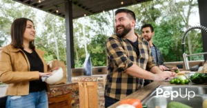 A group of family or friends gathers in a propane outdoor kitchen for entertaining.
