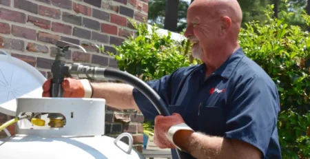 Jeff North, an experienced PepUp propane delivery driver, fills a 125-gallon residential propane tank after the homeowner converted from electric to propane in Easton, MD.