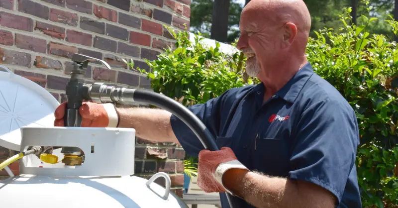 Jeff North, an experienced PepUp propane delivery driver, fills a 125-gallon residential propane tank after the homeowner converted from electric to propane in Easton, MD.